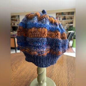Hand spun wool, hand knit hat in beautiful colors of blue and rust. Beanie style